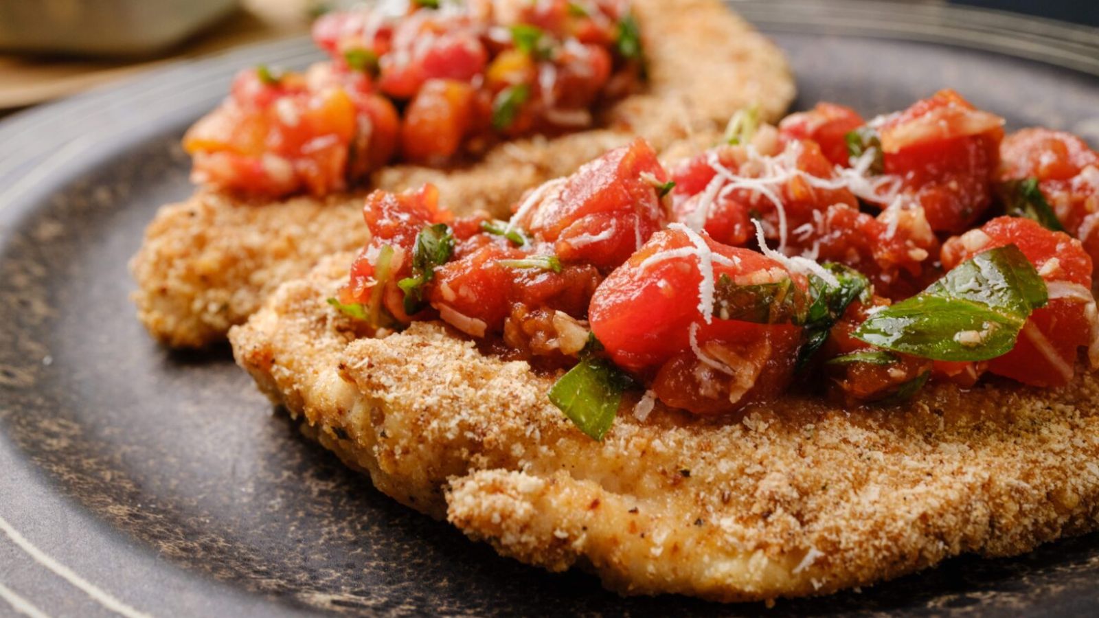 Parmesan crusted chickens on a plate.