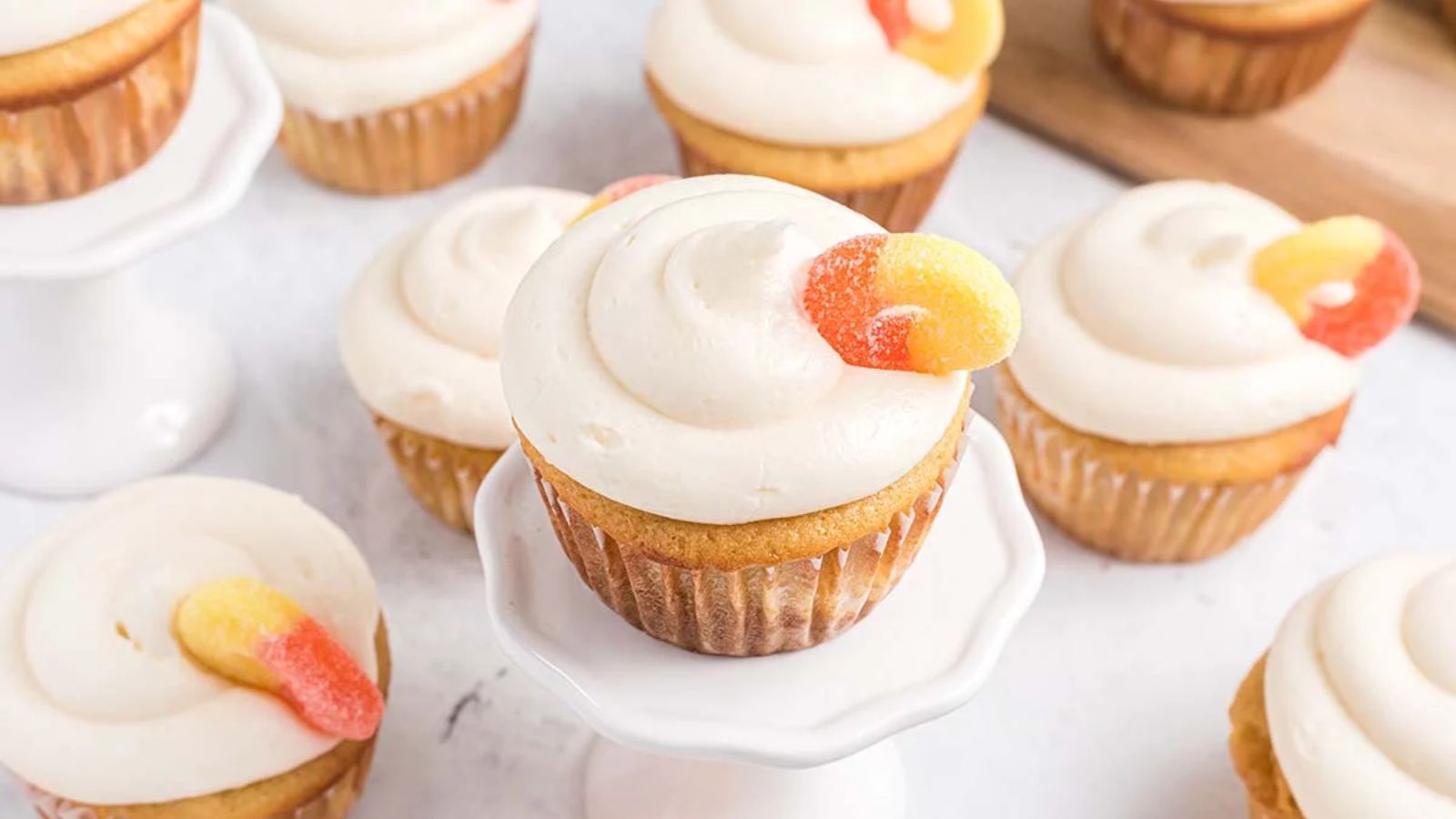 Peach cupcakes on a white surface.