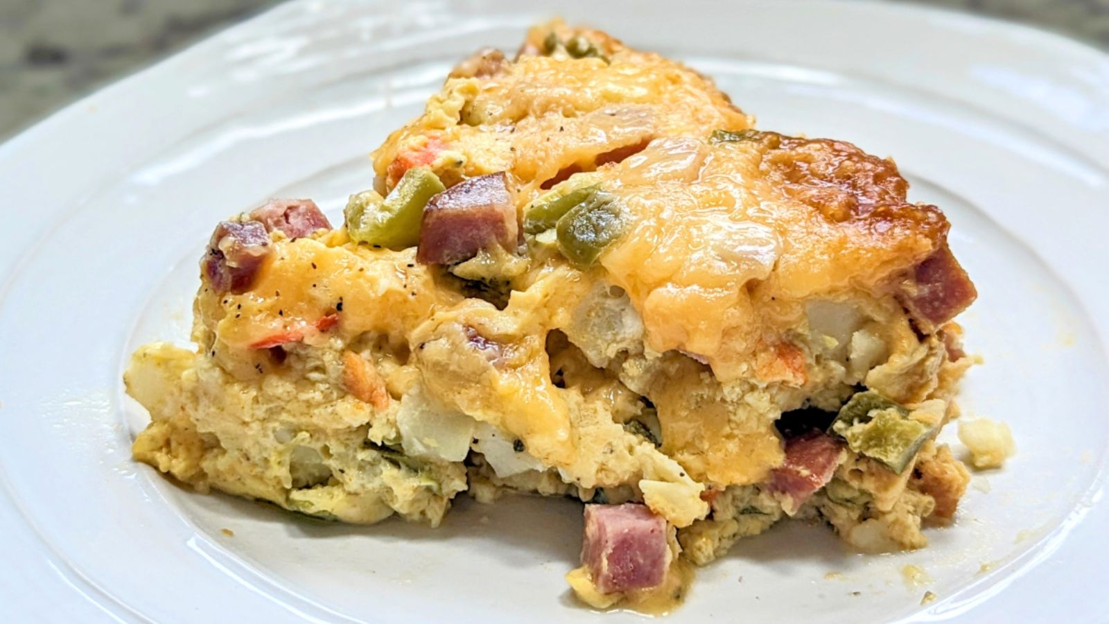 A slice of omelette casserole on a plate.