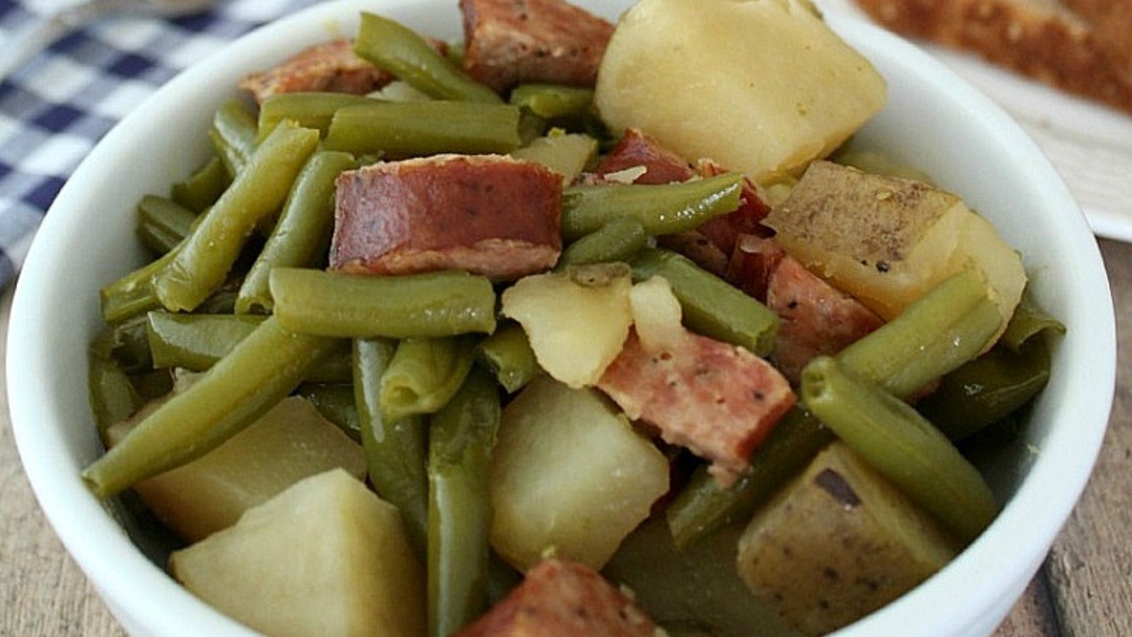 Green beans, potatoes and sausage in a bowl.