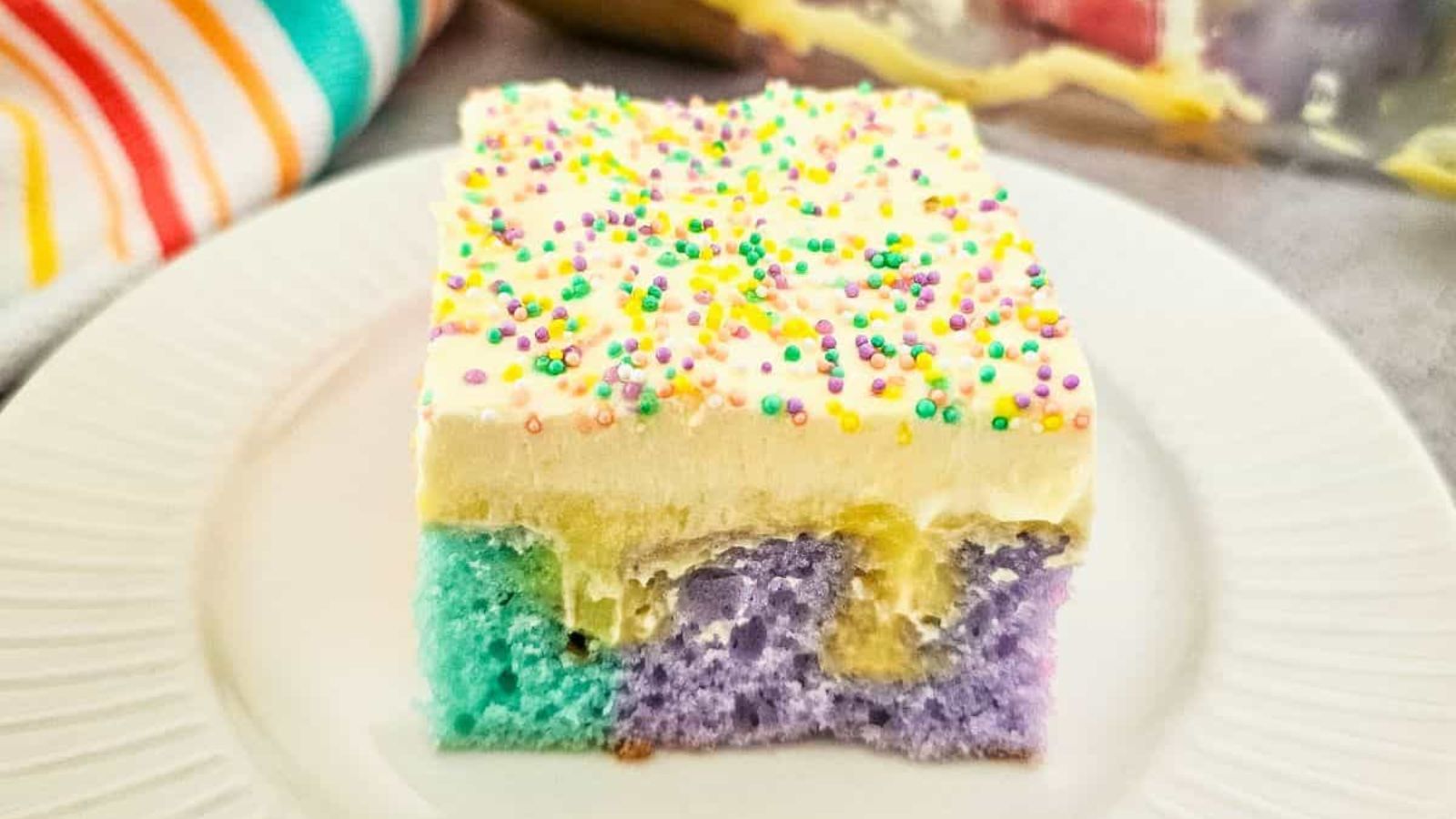 A slice of colorful poke cake.