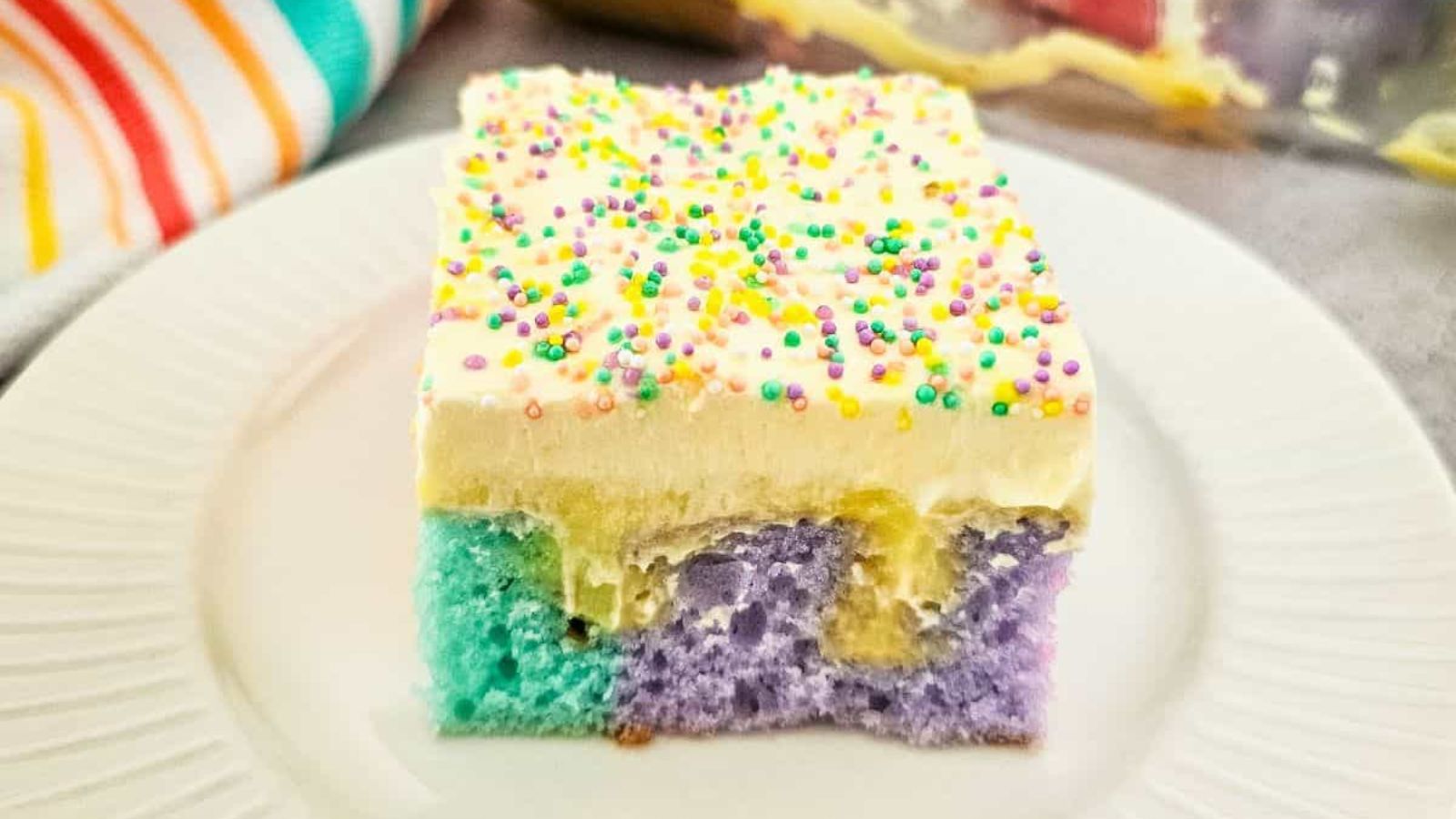 A slice of poke cake on a plate.