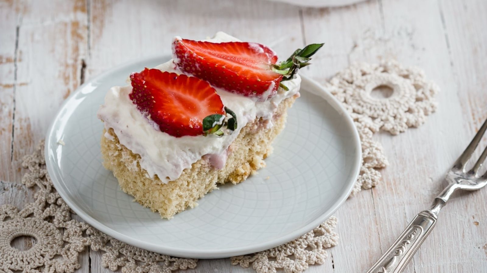 A slice of strawberry cheesecake on a plate.