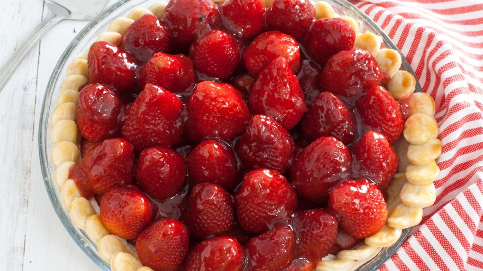 Cream cheese pie with fresh strawberries on top.