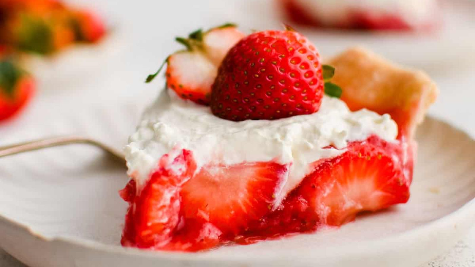 A slice of strawberry pie on a plate.