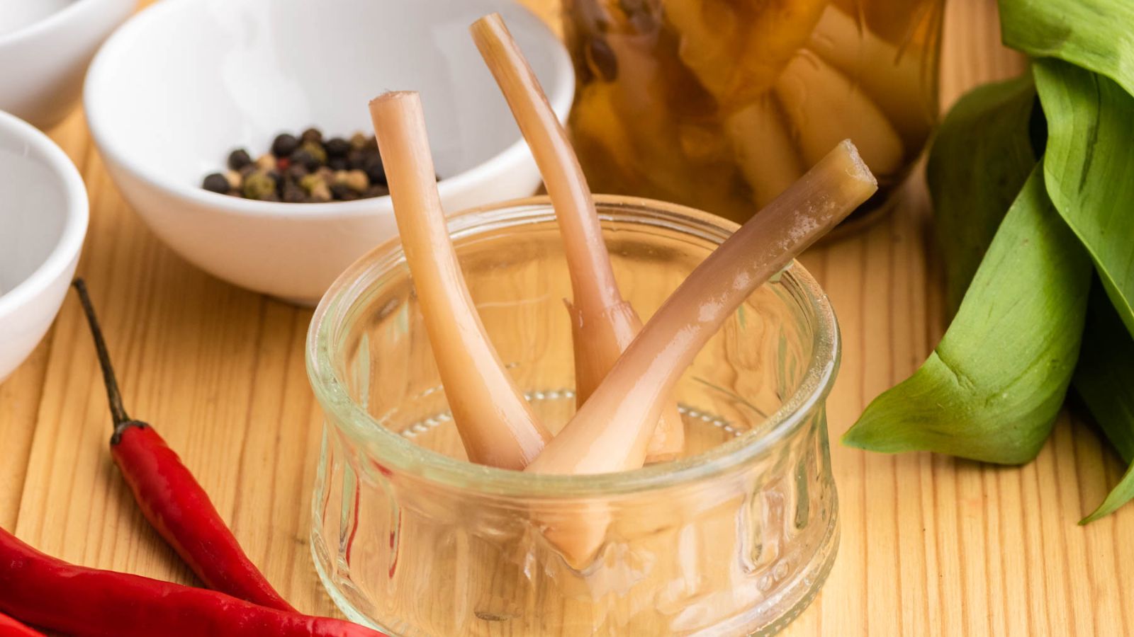 Sweet pickled ramps in a glass.