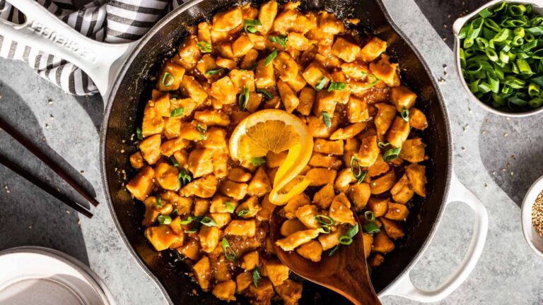 Skillet filled with orange chicken.