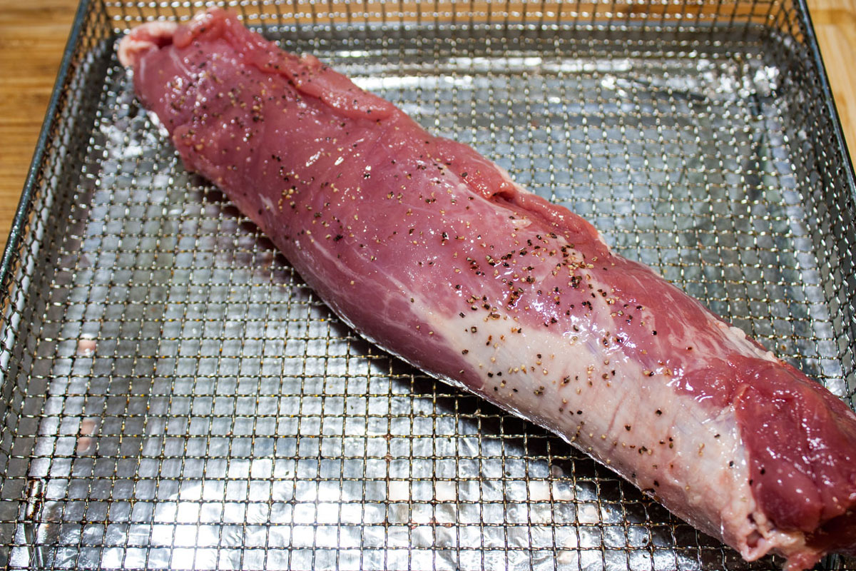 Pork tenderloin roast on air fryer rack.