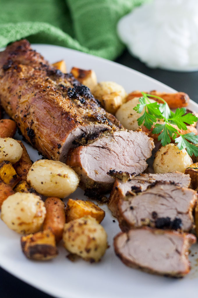 Pork loin surrounded by roasted vegetables