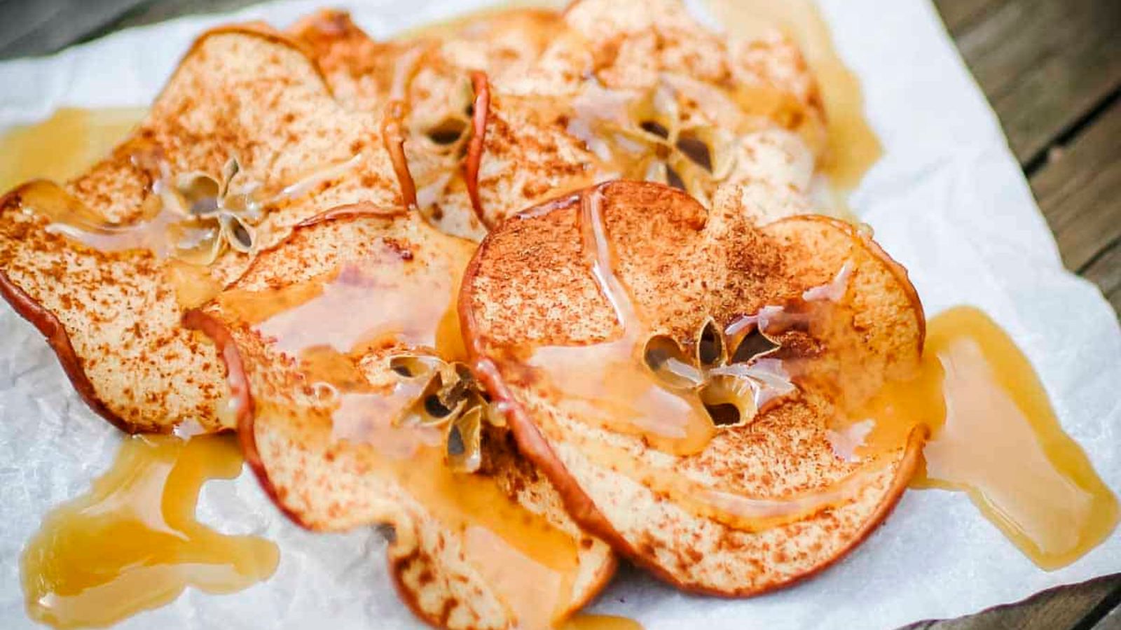 Apple chips covered in caramel sauce.
