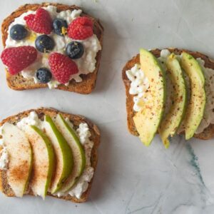 Cottage cheese topped toast with various toppings.