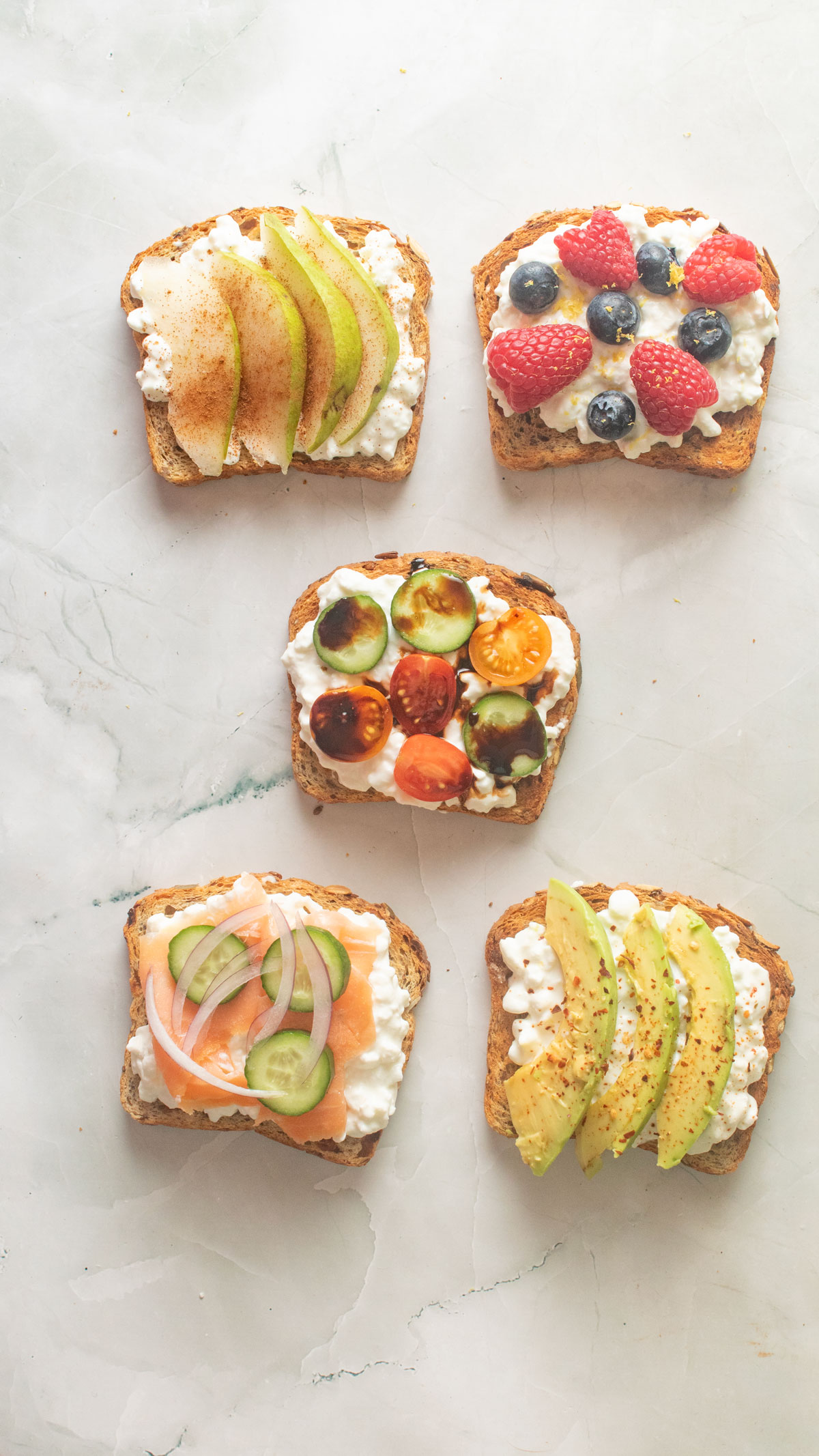 Five types of cottage cheese toast on a white board.