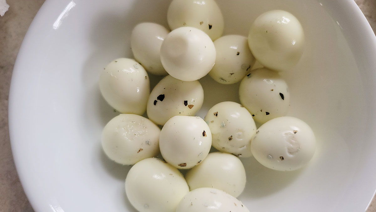 Peeled eggs with small pieces of the shell still attached.