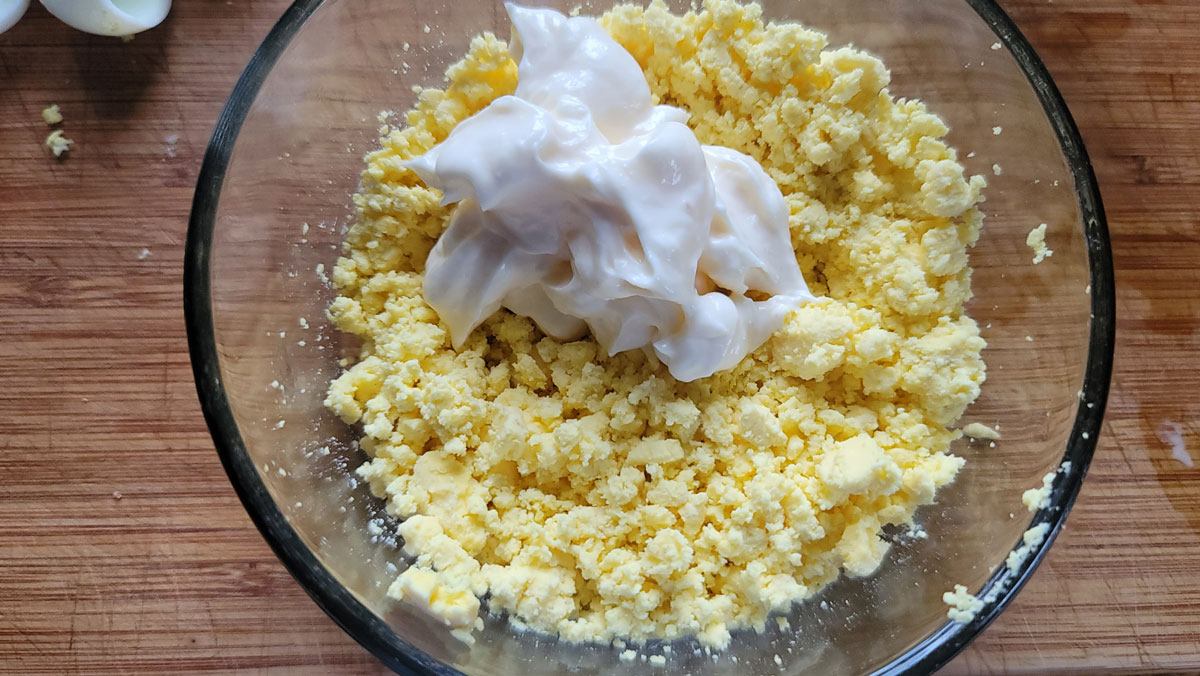Mayonnaise added to the eggs.