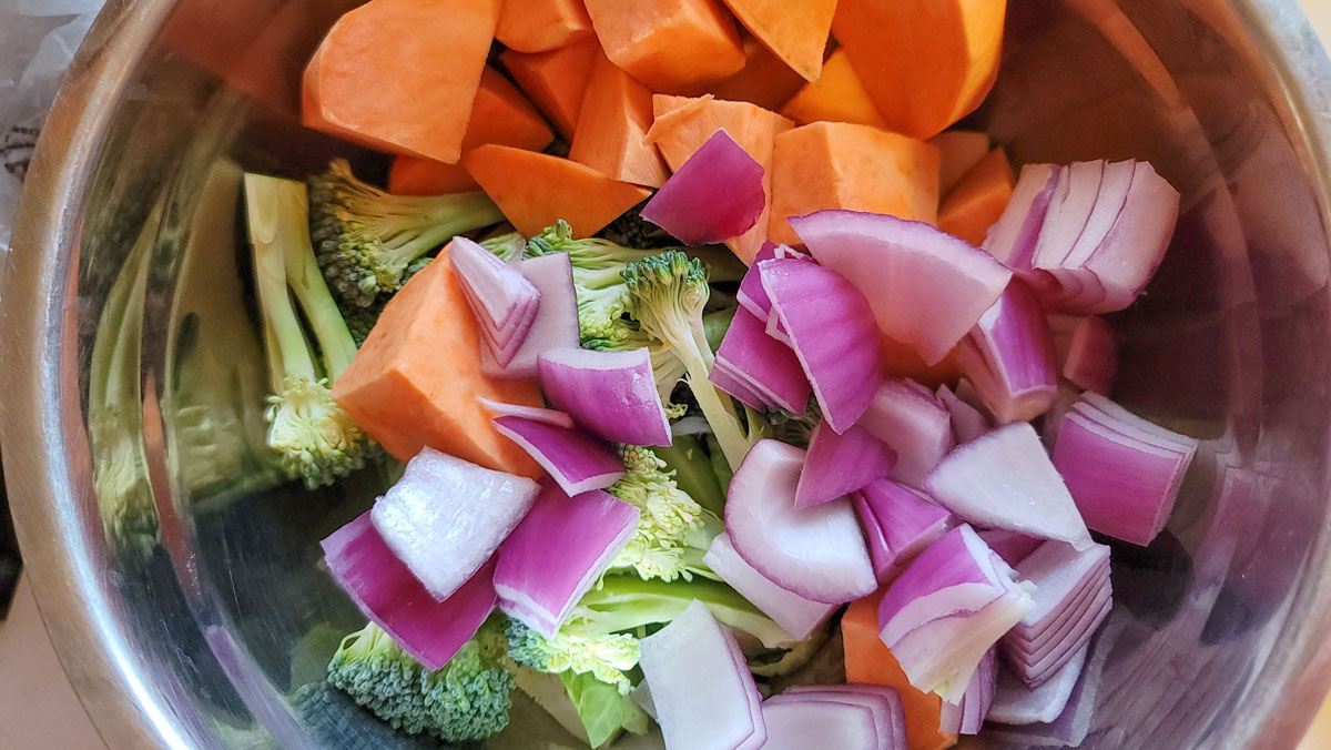 Onions, sweet potatoes and broccoli added to the bowl.