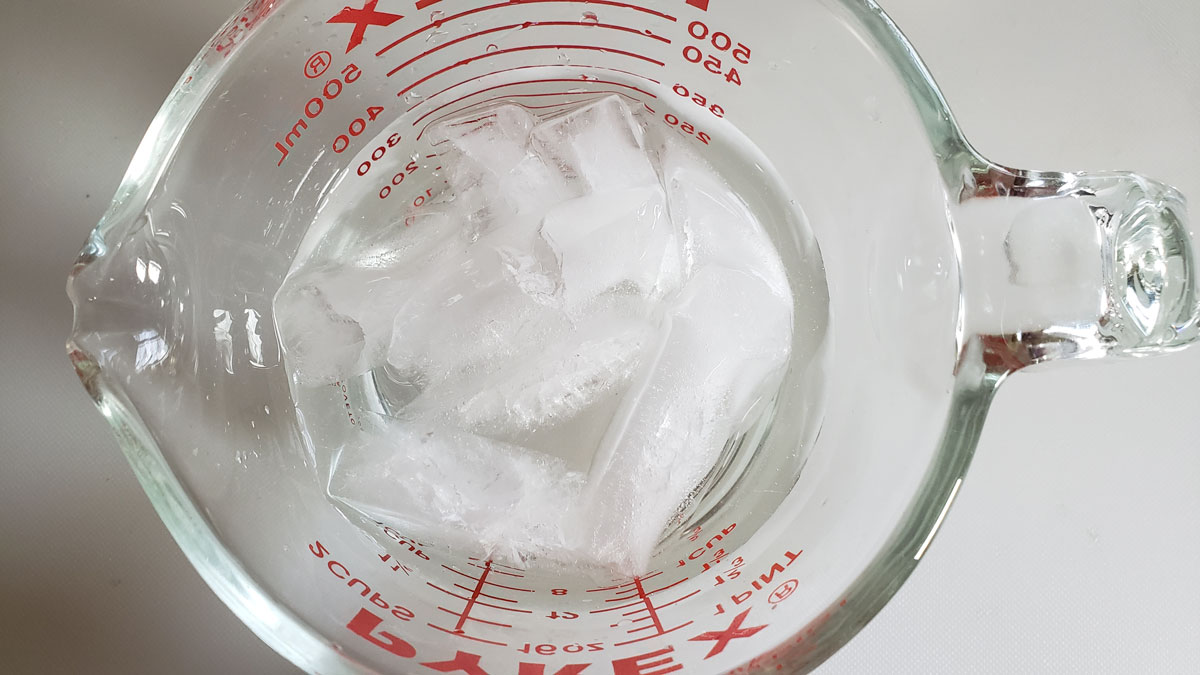 Ice water in a measuring cup.