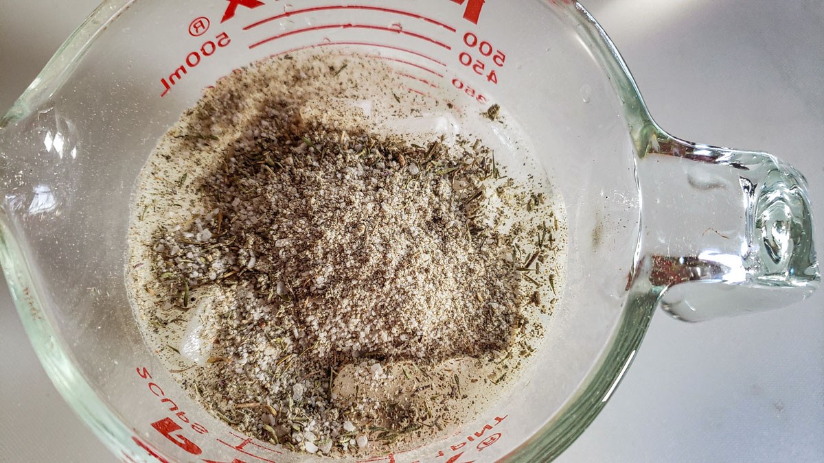 Spices added to the measuring cup.