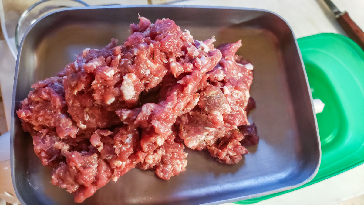 Sausage meat in the hopper of the sausage stuffer.