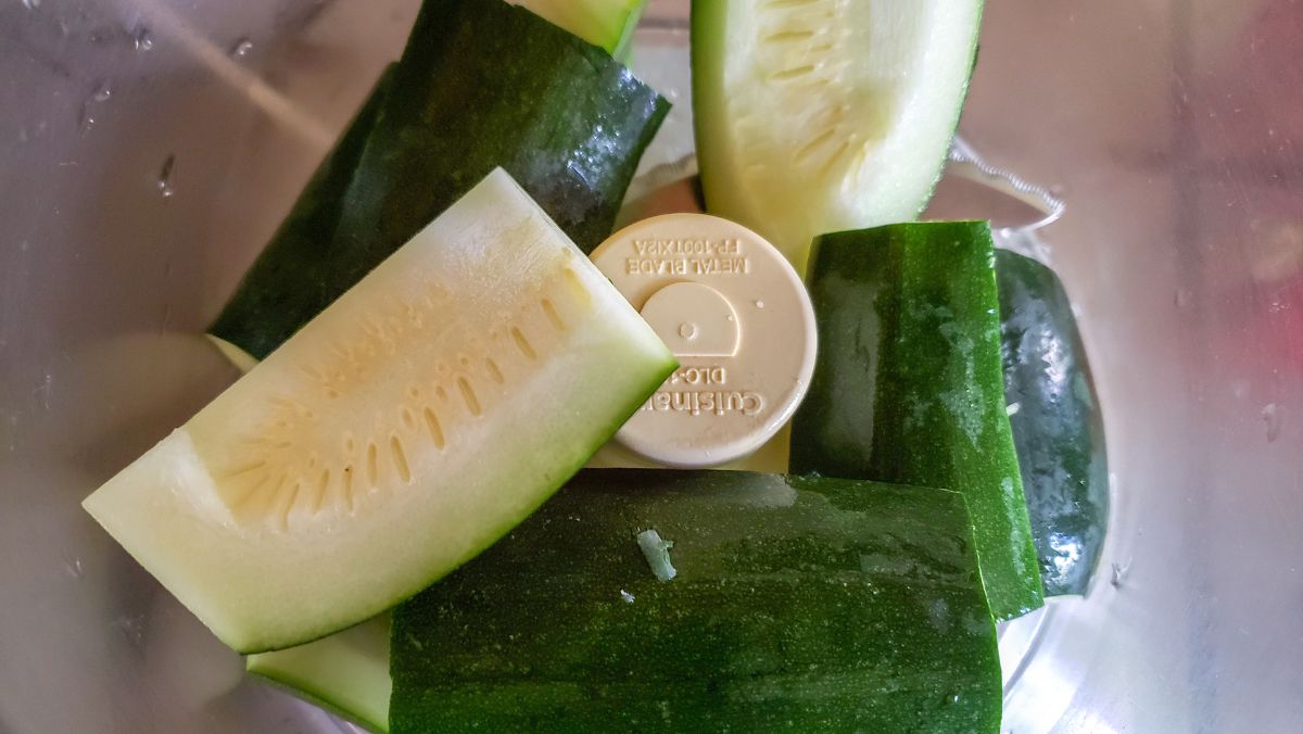 Zucchini cut width-wise and added to food processor bowl