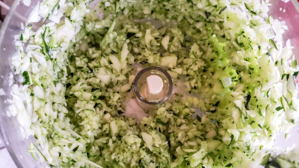 Chopped up zucchini in a the food processor.