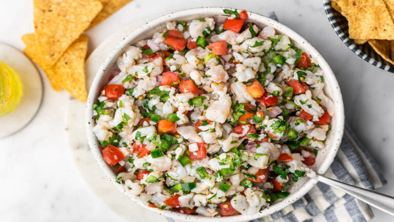 Shrimp ceviche is a white bowl with chips.