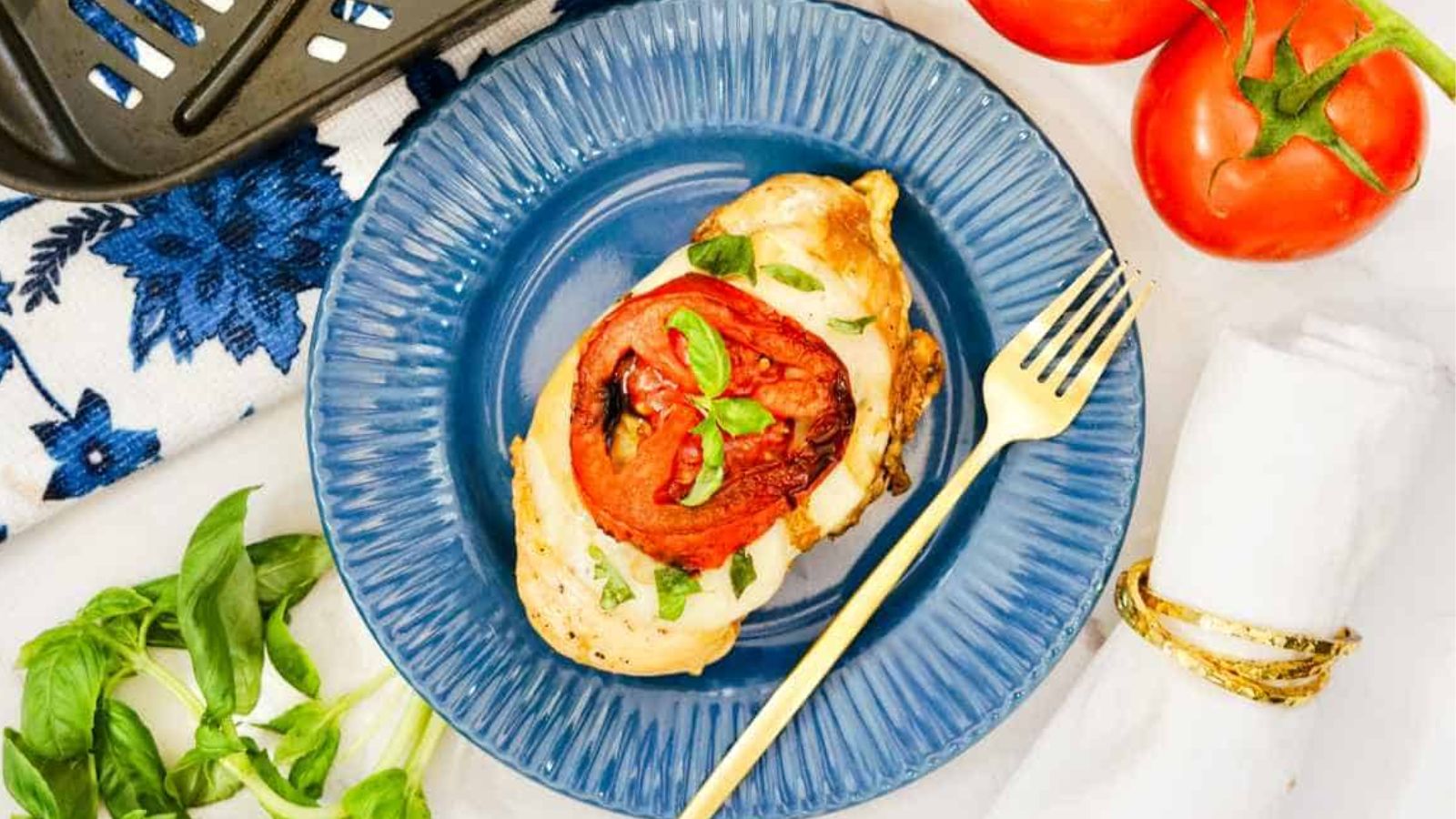 Caprese chicken on a plate.
