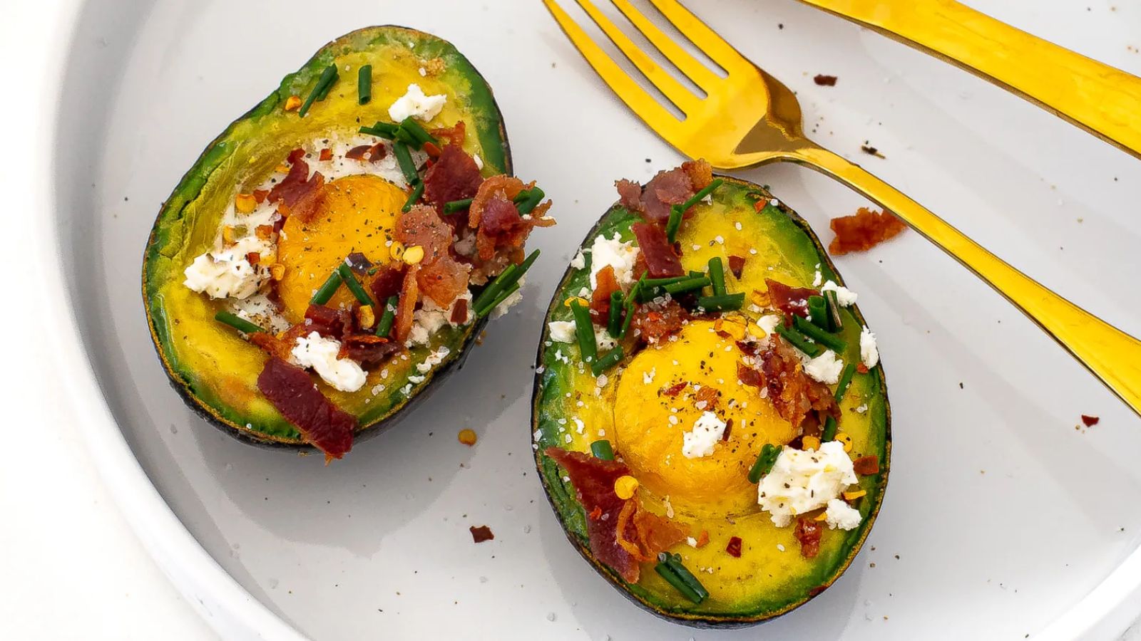 Baked eggs in avocado close up shot.