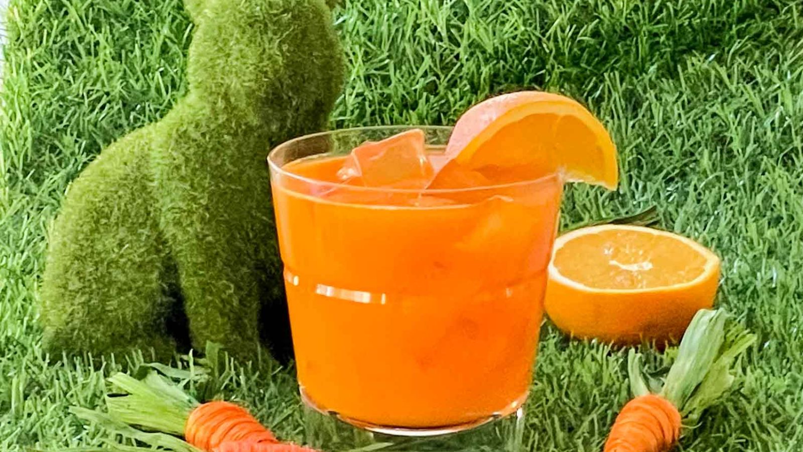 Bunny tonic cocktail with sliced oranges on grass.