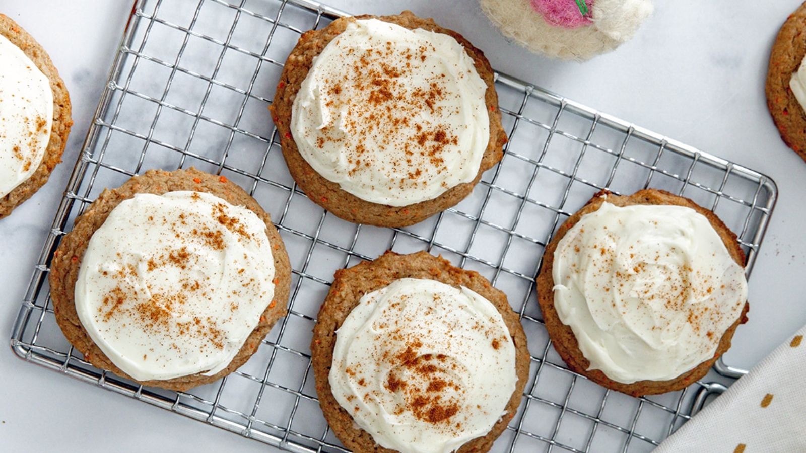Carrot cake cookies on a drying rack.