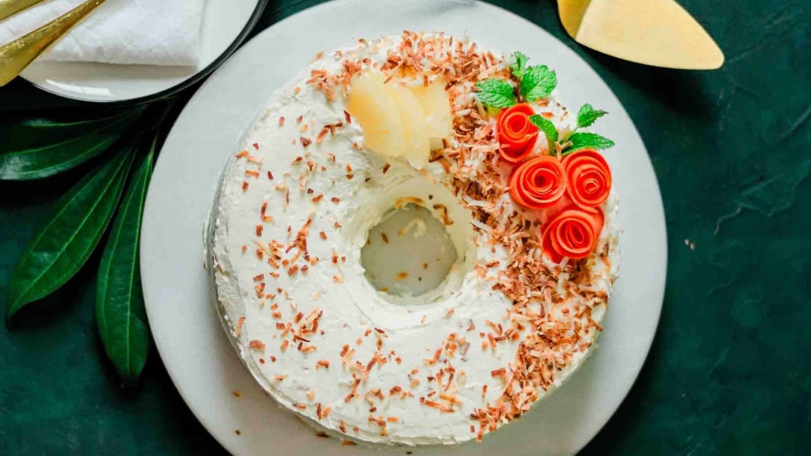 Carrot cake with pineapple and coconut on a plate.