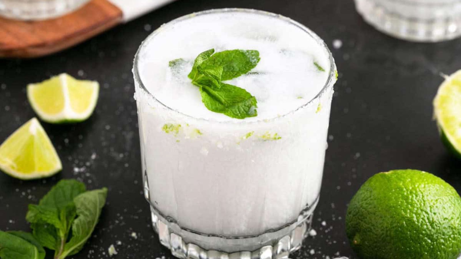 Coconut mojito in a glass with sliced lime.