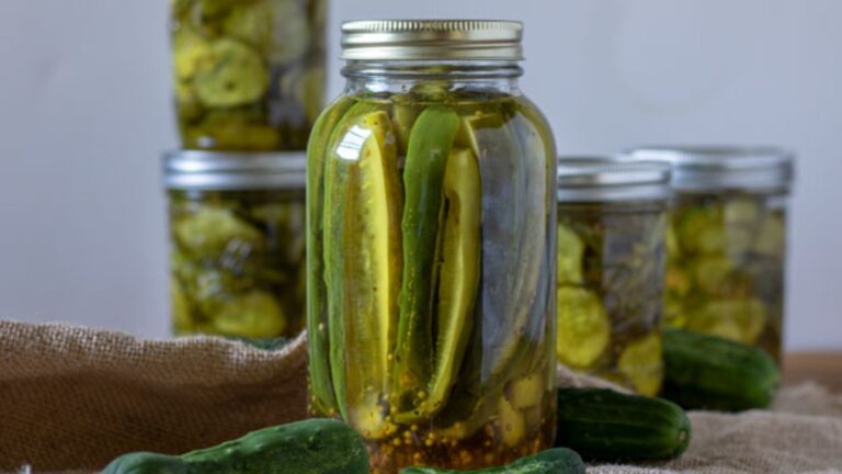 Jars of sweet pickles on burlap.