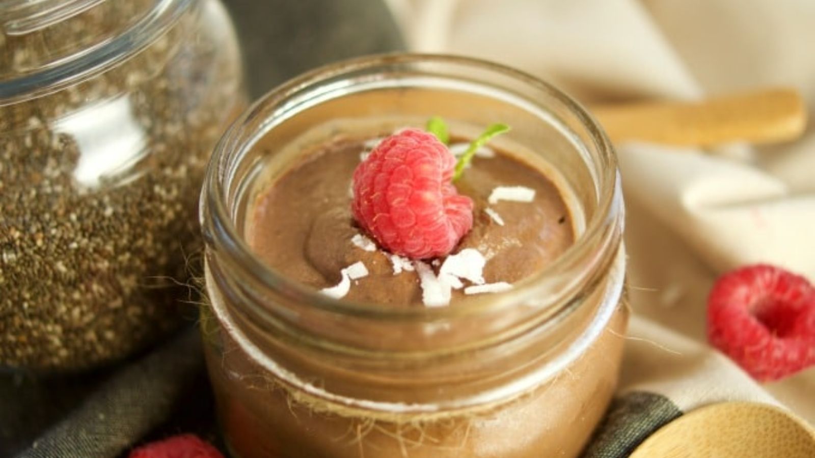 chocolate chia pudding with strawberry topping in a jar.