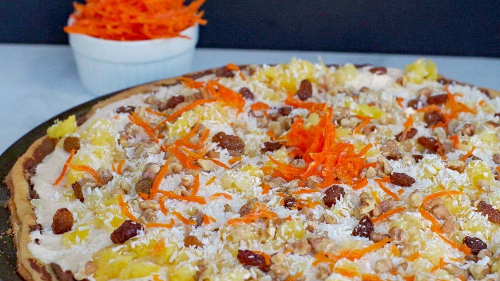 Carrot cake with grated carrots on top.