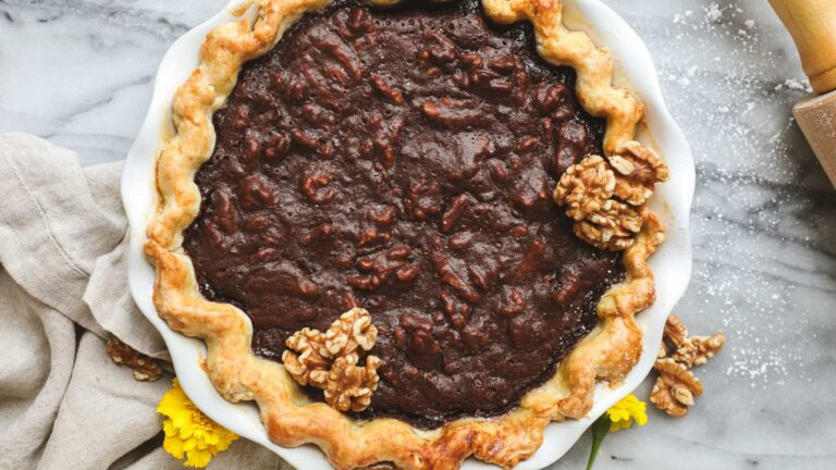 Chocolate pie with maple on a white board.