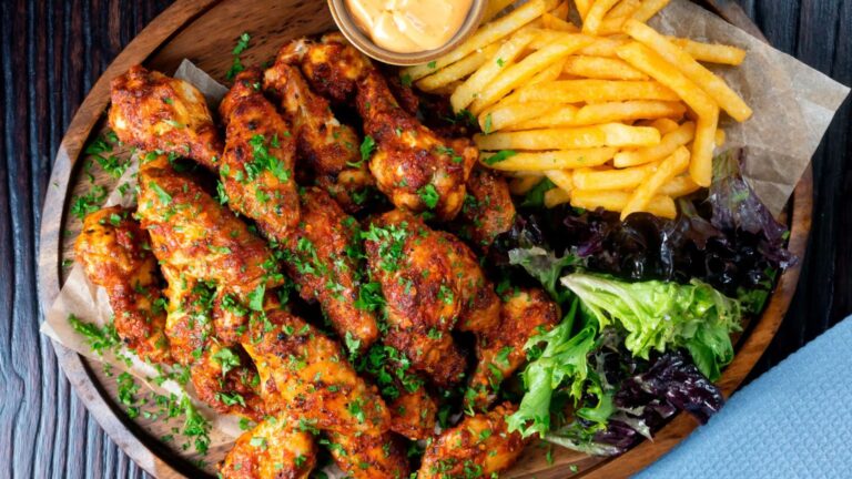 Chicken wings with fries and dip.