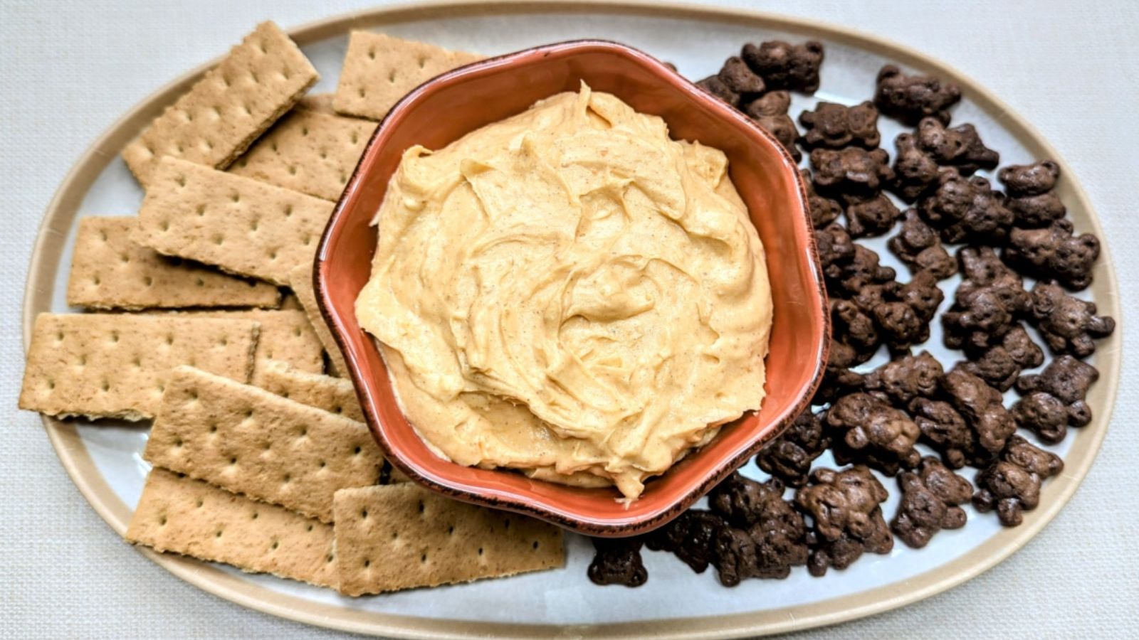 Pumpkin cheesecake dip with breads on the side.