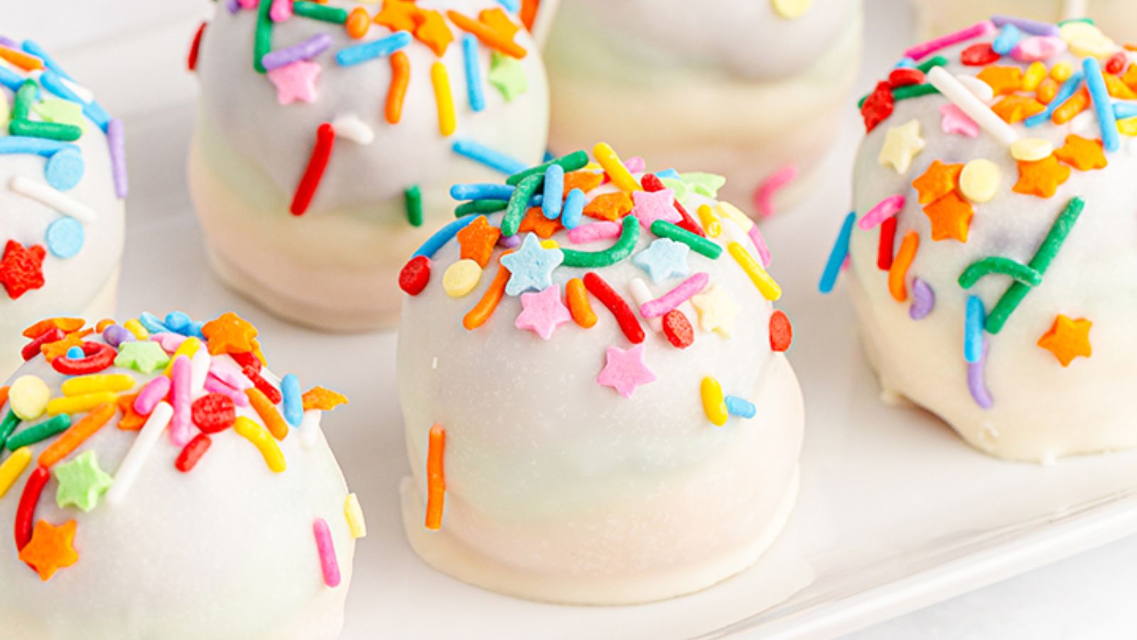 Rainbow cake balls with sprinkles close up shot.