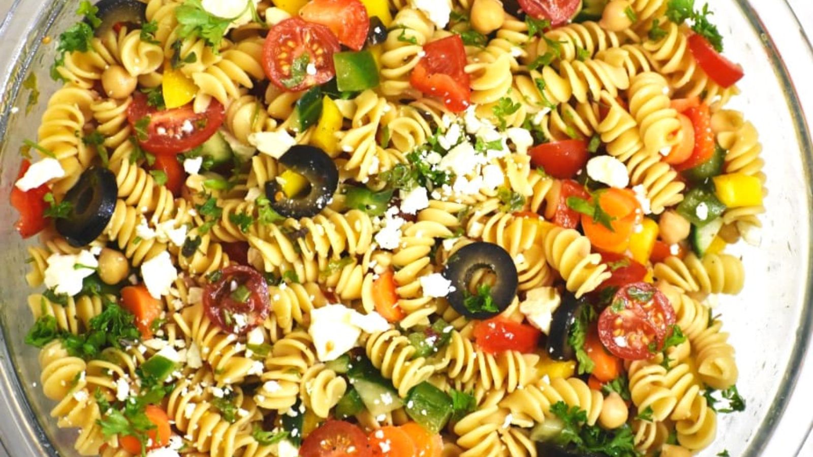 Rainbow pasta salad close up shot.