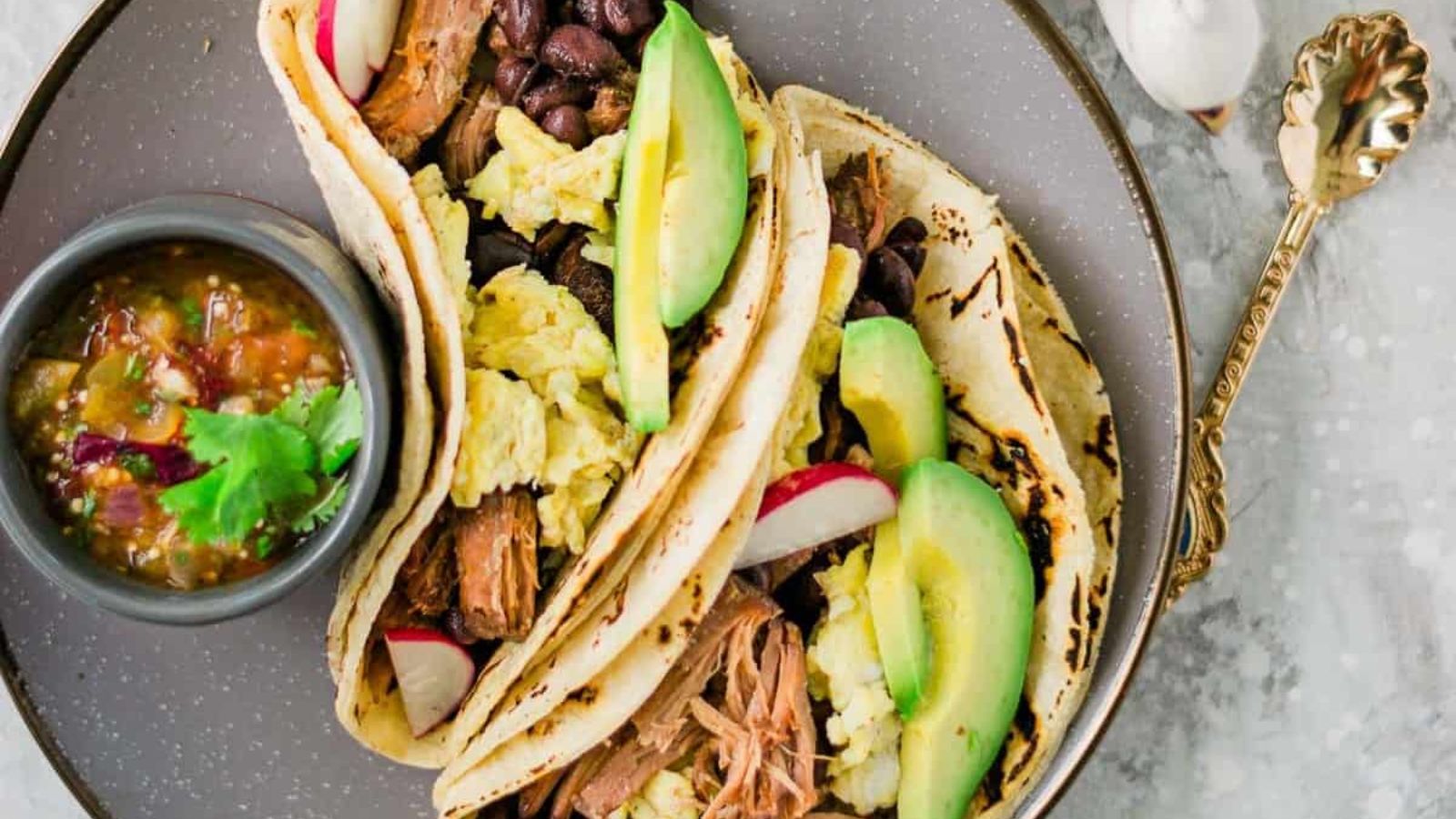 Pork carnitas tacos on a plate.