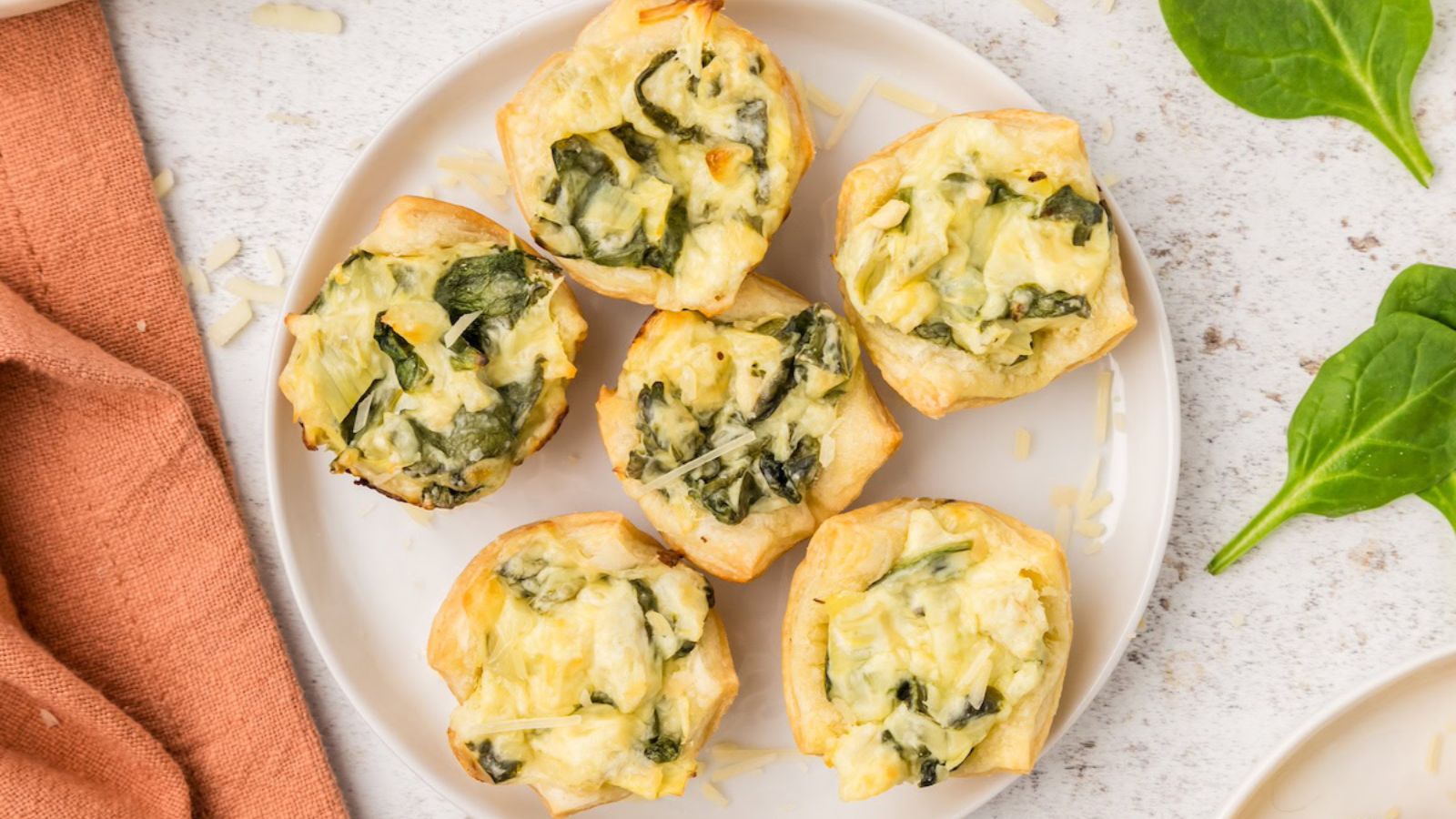 Spinach artichoke bites on a plate.