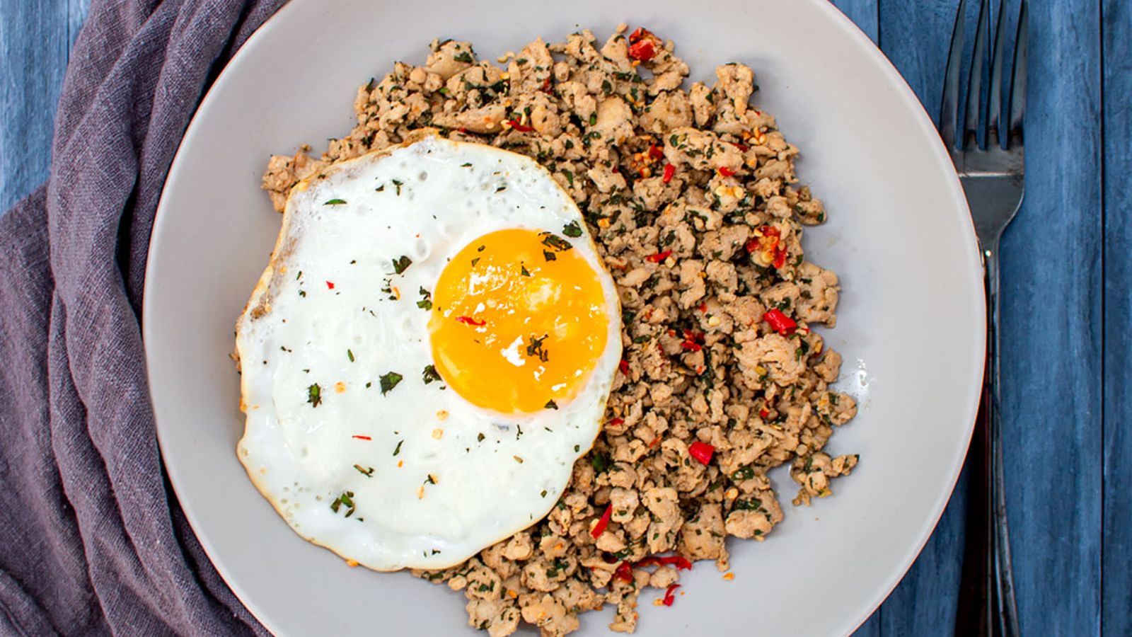 Thai basil chicken with egg on a plate