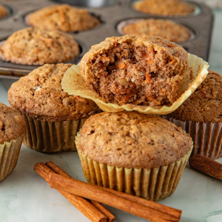 Carrot muffin broken in half to reveal the inside.