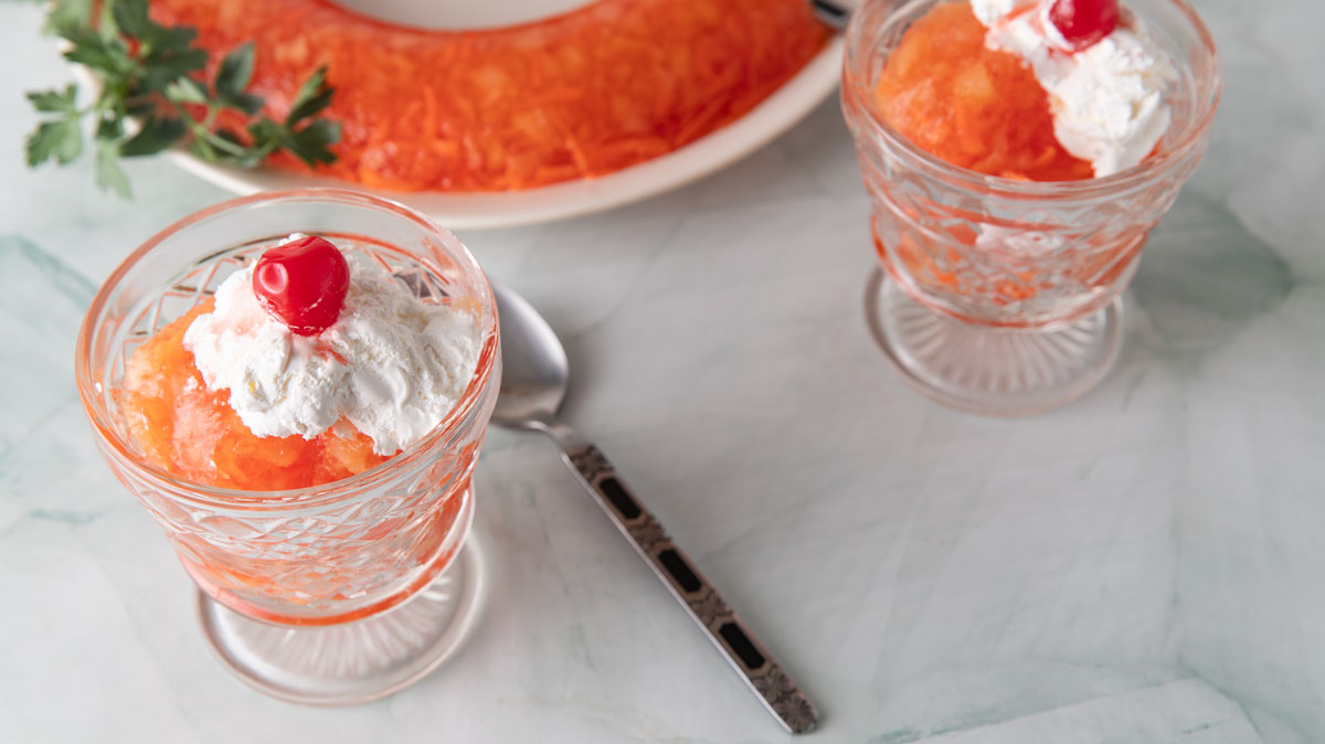 Jello in individual glasses with whipped cream on them.