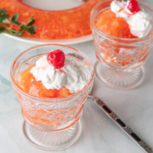Orange carrot Jello Salad in small serving glasses.