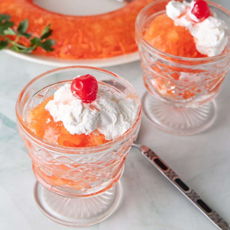 Orange carrot Jello Salad in small serving glasses.