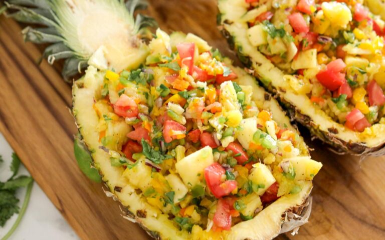 Pineapple salsa in halved out pineapples.