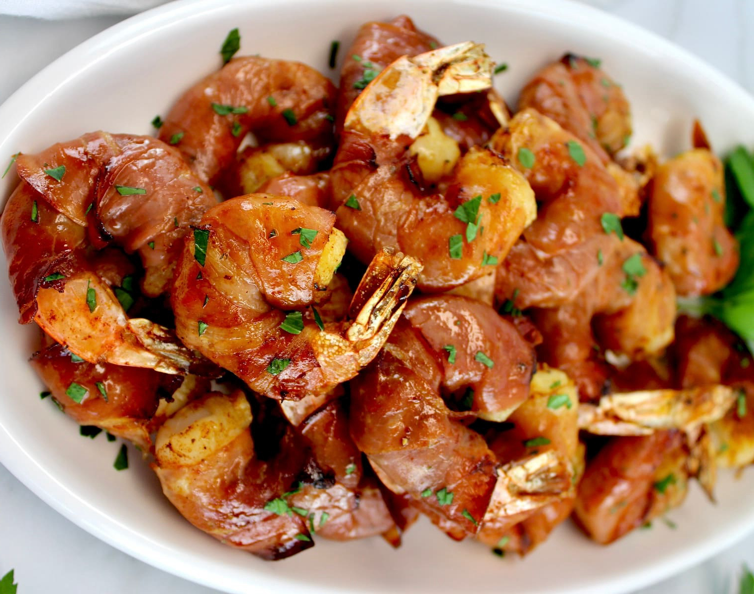 Prosciutto wrapped shrimp on a large platter.