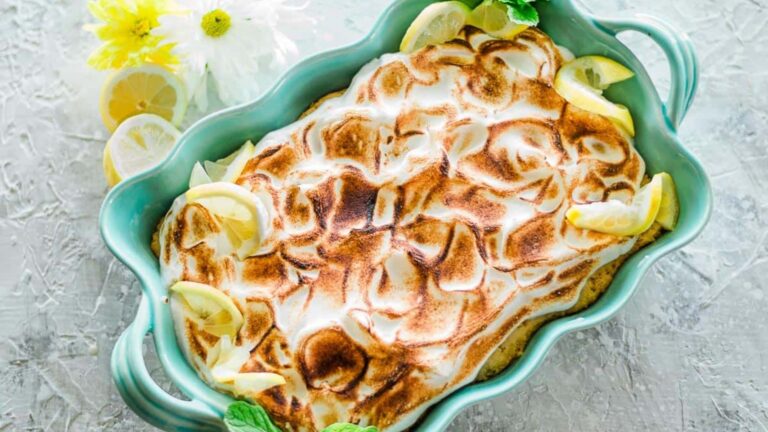Lemon Tres Leches cake with lemon in a glass tub.