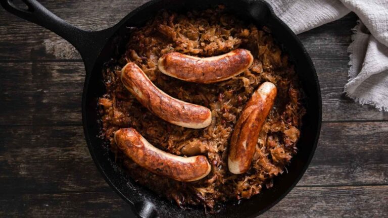 top view shot of bratwurst sausage on a frying pan.